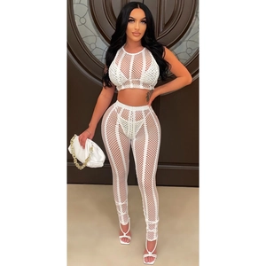 Detail view of white mesh see-through rhinestone set with sleeveless crop top and high-waist pants