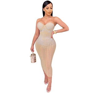 Detail of champagne bodycon party dress featuring sparkling rhinestones and mesh fabric