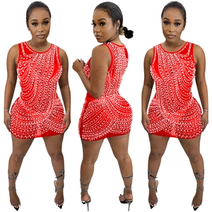 Detail of red sleeveless bodycon dress with multi-layered white pearl chain embellishments