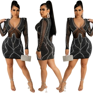 Detailed view of deep V-neck mesh panels and sparkling rhinestones on the black mini dress