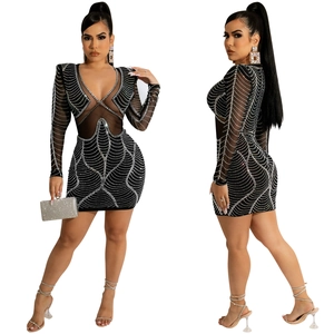 Detail of sheer mesh patchwork and sparkling silver rhinestones on a black mini dress