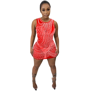 Detail of red bodycon mini dress featuring intricate white pearl and rhinestone fringe