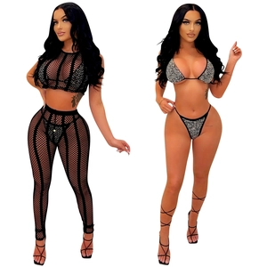 Detail of four-piece black mesh set with rhinestones featuring bikini and sheer trousers