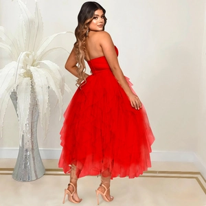 Detail of red strapless tulle dress showing layered puffy skirt and slimming silhouette