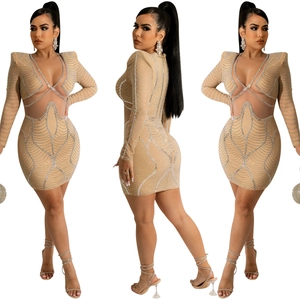 Detail view of a beige long sleeve dress with rhinestones and waist cut-outs