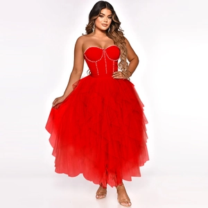 Close-up detail of red strapless bodice with elegant white beadwork and mesh layers