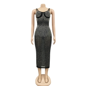 Detailed view of black mesh bodycon dress with vertical pearl and rhinestone embellishments