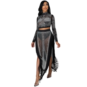Close-up of black mesh fabric with silver rhinestones and long fringe detailing