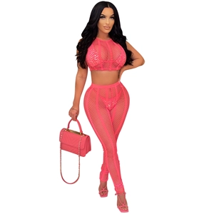 Detail of hot-drilled mesh sleeveless top and leggings set in vibrant pink color