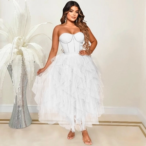 Detail of white tube top mesh dress featuring vertical rhinestones and tiered ruffles
