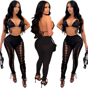 Detail of black mesh two-piece set with side lace-up cutout pants and halter top