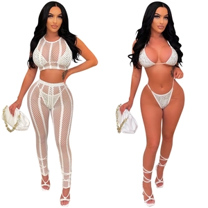 Detail of white mesh four-piece set with rhinestone bikini and high waist trousers
