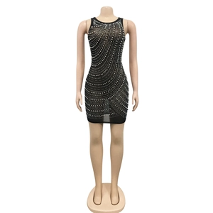 Close-up of sparkling rhinestones and mesh texture on a black sexy bodycon dress