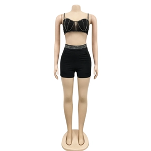 Detail shot of black two-piece set featuring silver rhinestones and stud embellishments