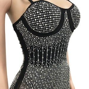 Detailed view of black mesh corset top with intricate silver rhinestone patterns