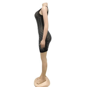 Side view of black bodycon mini dress with rhinestones and pearls on mannequin