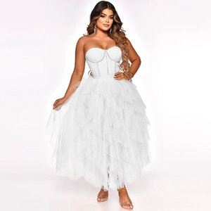 Detail of white tube top mesh dress featuring crystal embellishments and layered tulle skirt