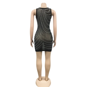 Detail of black mesh mini dress featuring wavy rhinestone patterns and sheer fabric back