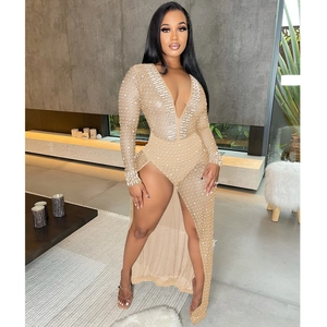 Detail of nude mesh maxi dress featuring white rhinestones and deep V-neck with high slit