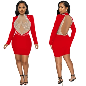 Detail of red long sleeve bodycon dress with pearl embellishments and heart mesh cutout