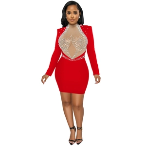 Close-up of red bodycon dress featuring sheer mesh cutout with pearl and bead embellishments