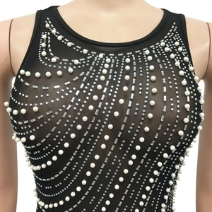 Close-up of see-through mesh top with radiant faux pearls and rhinestone embellishments