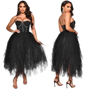 Close-up of black strapless dress featuring rhinestone trim and tiered tulle layers