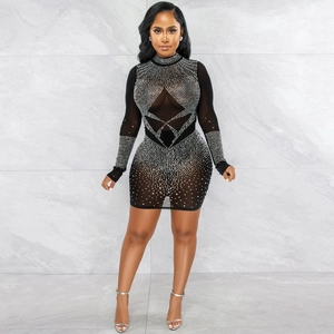Detail of sheer black mesh mini dress featuring intricate silver rhinestone patterns