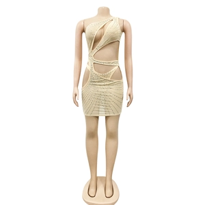 Close-up of beige one-shoulder mini dress with cutout details and sparkling rhinestones