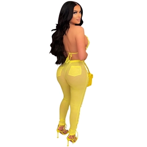 Detail view of yellow mesh see-through top and pants set with side drawstring features