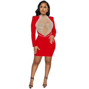 Close-up of red bodycon dress with sheer mesh, rhinestones and pearls detailing