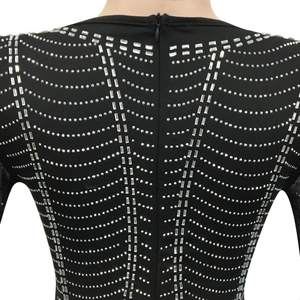Detailed back view of a black mesh dress featuring wavy silver rhinestones and a hidden zipper