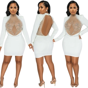 Detail of white mini dress with mesh patchwork, pearls and rhinestones on high neck