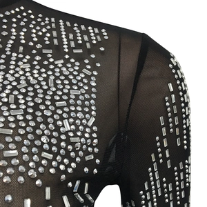 Detail of black sheer mesh fabric with sparkling silver rhinestones in geometric patterns