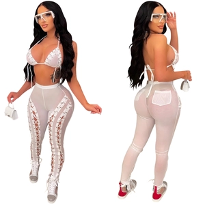Detail view of white mesh see-through pants with criss-cross lace-up side cutouts
