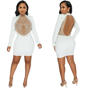 Detail of white bodycon dress featuring faux pearls, rhinestones and mesh patchwork