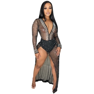 Detail of black mesh dress featuring sparkling rhinestones and a high side slit