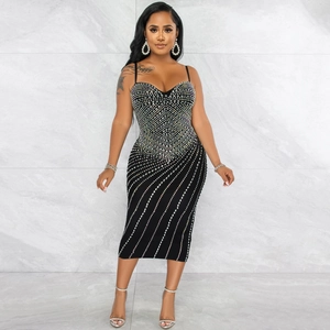Close-up of black bodycon dress featuring intricate silver rhinestone patterns and heart neckline