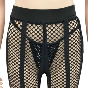 Detail of high waist fishnet leggings with sequins and elastic waistband in black color