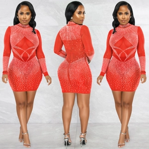 Detail of red mesh mini dress with intricate geometric rhinestone patterns and long sleeves