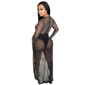 Detail of black sheer mesh dress with rhinestones showing the transparent fabric texture