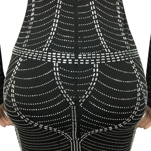 Close-up detail of silver rhinestones in a spider web pattern on black mesh dress