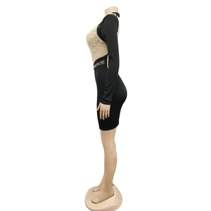 Close-up of sheer mesh back with white pearls and rhinestones on black bodycon dress