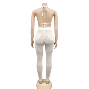 Detail of white mesh knit two-piece set featuring back cross-straps and rear pockets