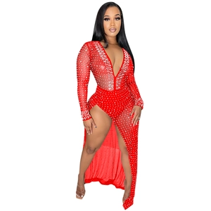 Detailed close-up of red mesh evening dress featuring sparkling silver rhinestones and deep V-neck