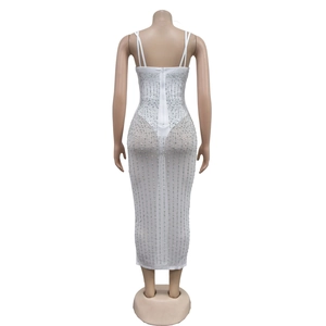 Detail of white mesh maxi dress featuring sheer fabric and vertical rhinestone patterns