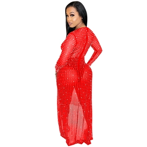 Detail of red sheer mesh maxi dress featuring delicate rhinestones and high slit cut