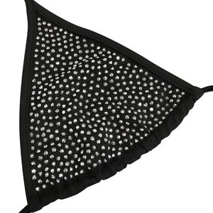 Close-up of black mesh lingerie top with shimmering silver rhinestones and gathered edges