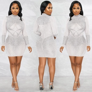 Close-up of white mesh bodycon mini dress with silver rhinestones in geometric patterns