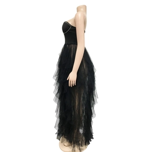 Detail of tiered black mesh ruffles and silver beaded trim on the strapless dress